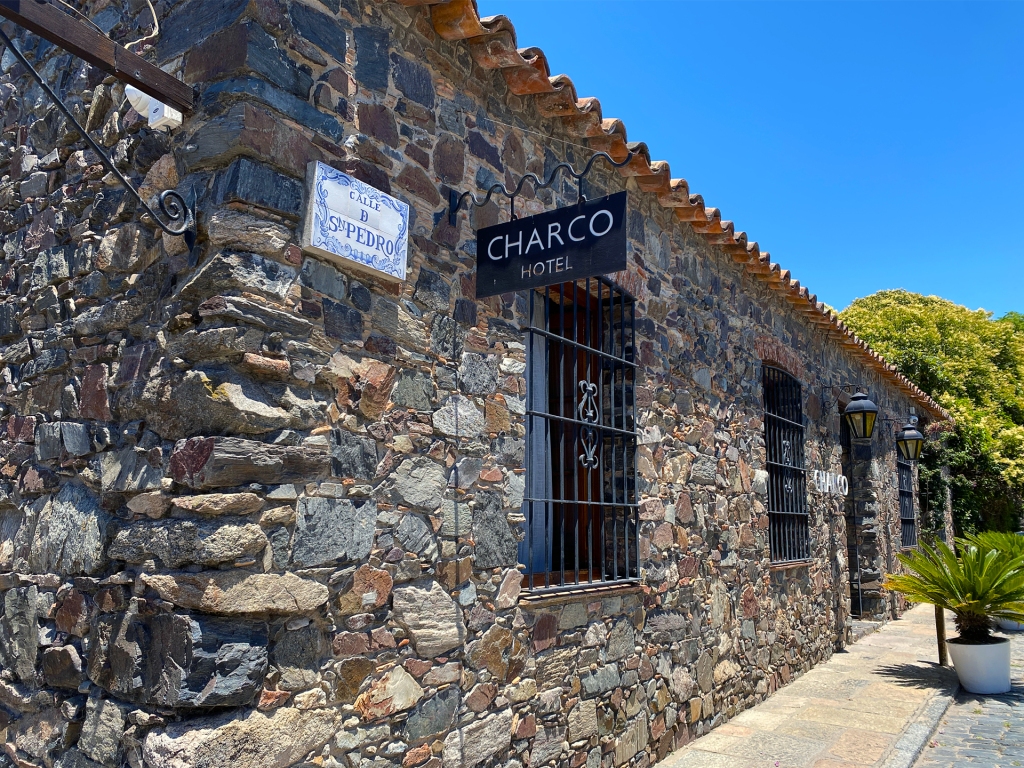 An old building made of Stone that has been converted into a hotel and restaurant named the Charco Bistro in Uruguay.