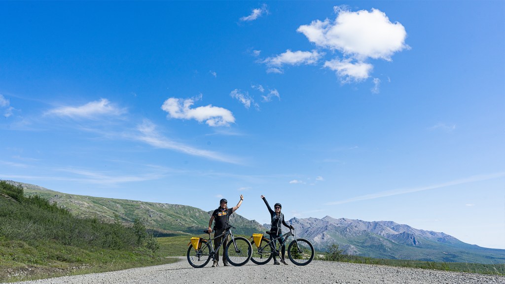 A couple posing with their bikes in Denali National Park, Alaska.