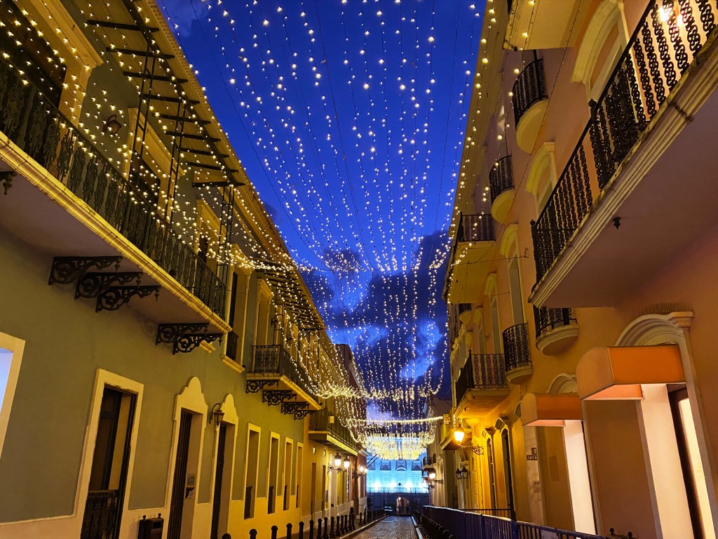 A colorful street in Old San Juan, Puerto Rico, with lights strung above the street.