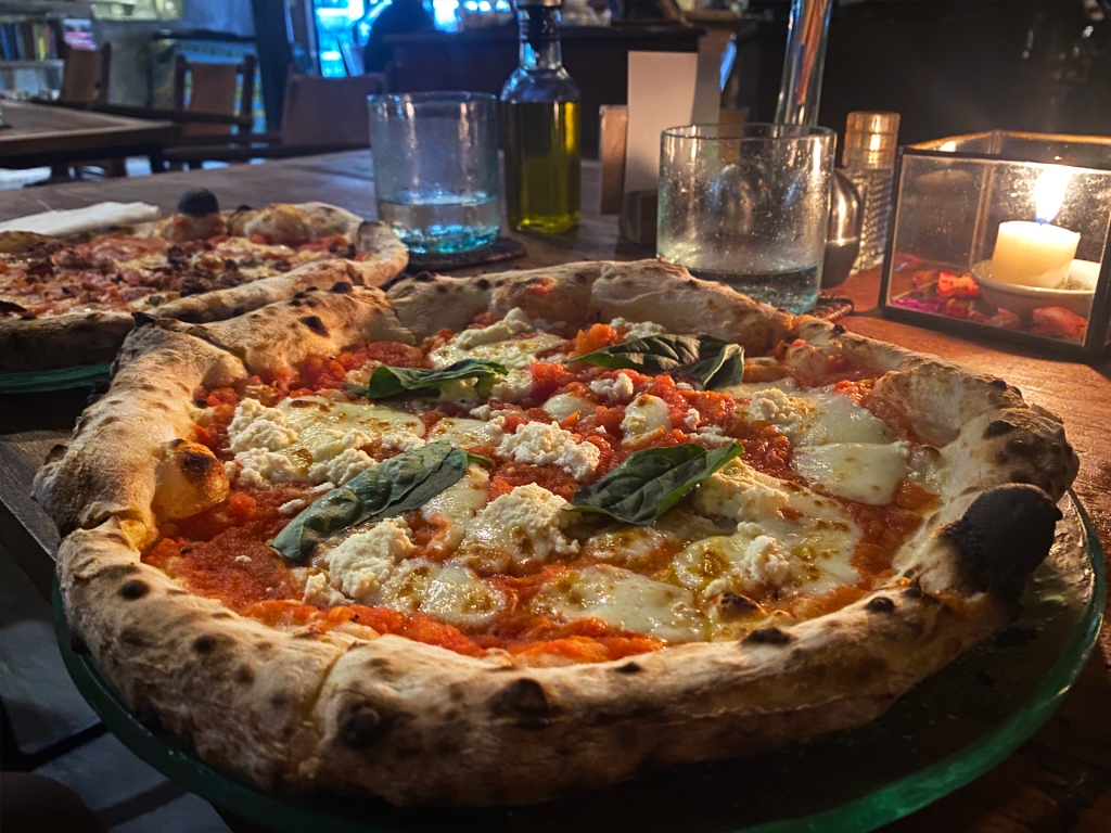 A photograph of a wood fired margherita pizza at Arte in Canggu, Bali.