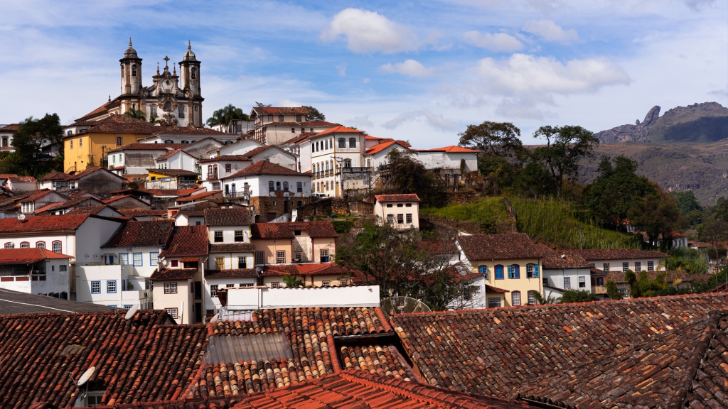 The city of Ouro Preto, Minas Gerais, Brazil. The orange tiled rooftops lining the hillside beneath the 17th century church.