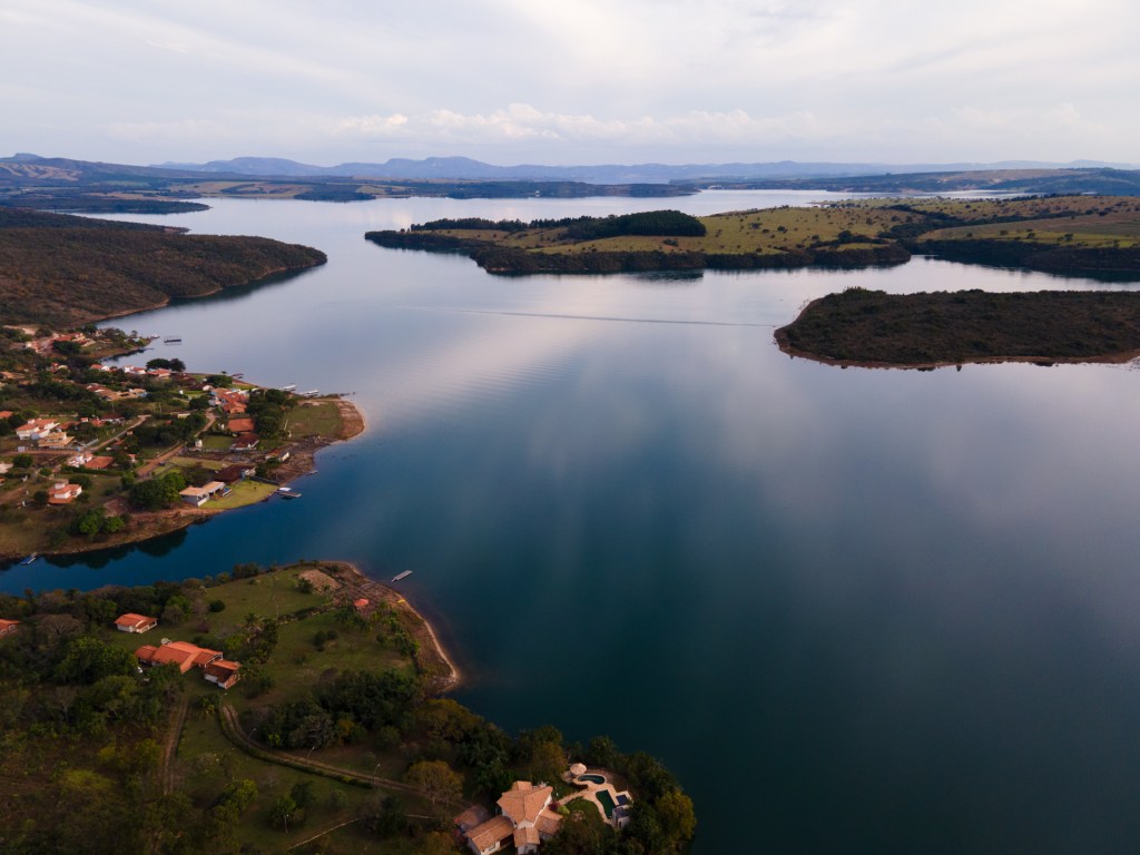 CapitĂłlio lake in CapitĂłlio, Minas Gerais, Brazil. A blue, glass looking lake from the aerial view.