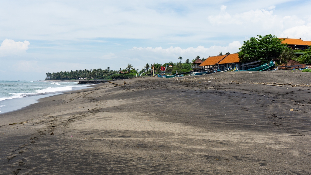 Pantai Munggu and Seseh Beach in Canggu, Bali. Black sand beaches with fishing boats.