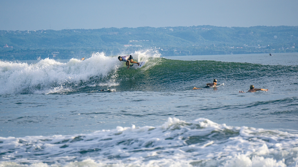 Surfing in Canggu, Bali. A surfer riding a wave on Canggu Beach, Echo surf spot.