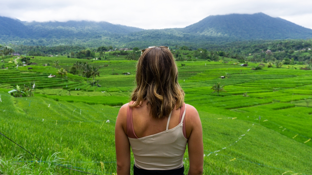 A woman overlooking rice terraces in Bali.