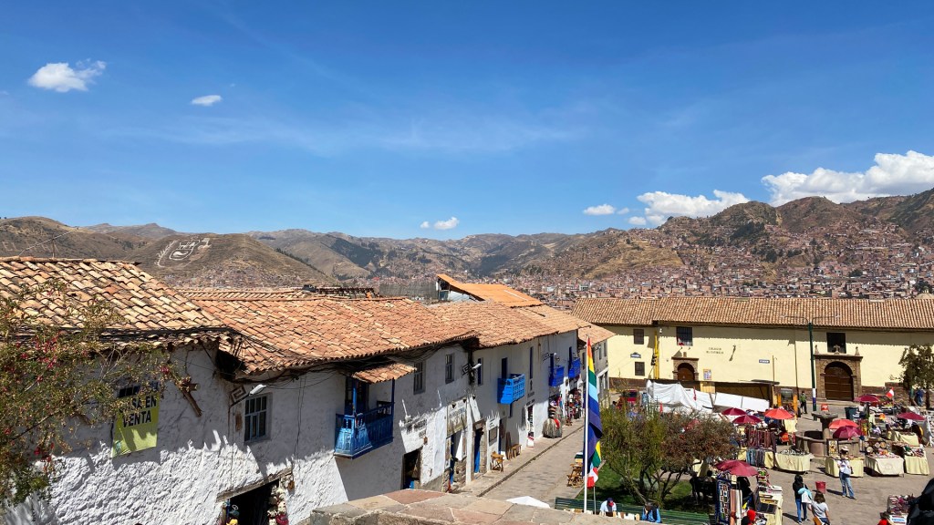 The historic buildings with brown and orange tile roofs in Cusco, Peru.