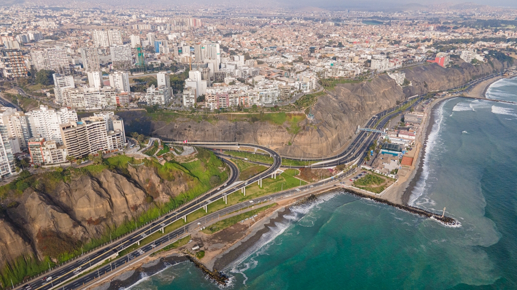 An aerial photo of Lima, Peru. A large city on top of a cliff, along the coast.