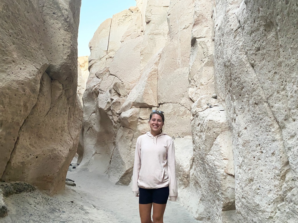 A woman standing in a white canyon made of sillar stone in Arequipa, Peru.