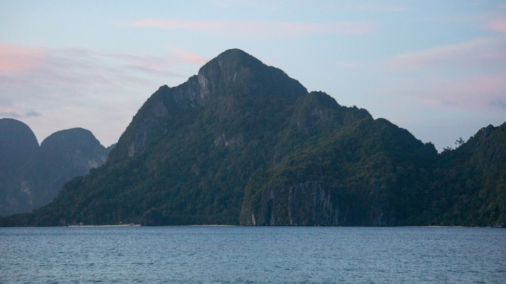 A large sea rock during the sunset at Las Cabanas Beach in El Nido, Palawan.