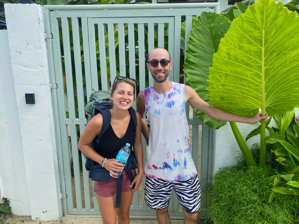 A man and woman standing in front of a hotel in Siargao, Philippines.